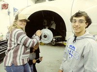 Students working on brakes of vehicle