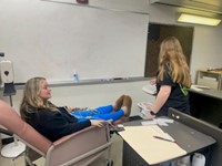 Phlebotomy students practicing blood draws